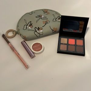 Ipsy bag with eyeshadow and lip gloss with blush.